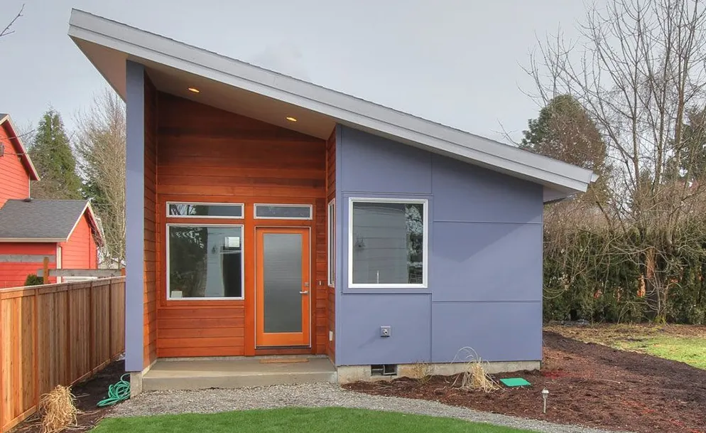 Single-storey shed-roof garden suite with a cedar entry and a small concrete step